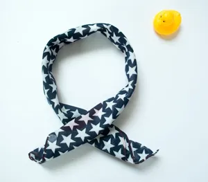 Dark blue bandana with white stars detail and stitched edges on white background