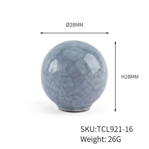 Detailed close-up of a light blue crackle ceramic round cabinet knob with 28mm dimensions