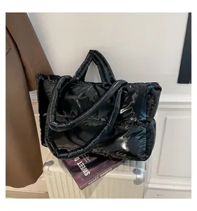 Stylish glossy black space cotton puffy tote bag displayed on a suitcase lifestyle detail