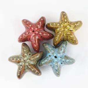 Detailed view of colorful leopard print ceramic starfish drawer handles