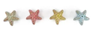 Detailed view of four colorful leopard print starfish ceramic knobs for cabinets