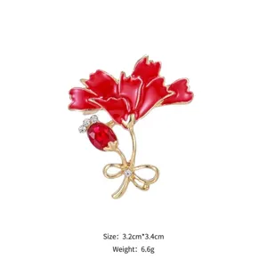 Elegant red enamel carnation brooch with ruby-red gemstone and gold-tone details