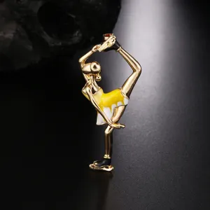 Detailed macro shot of an enamel ice skating girl brooch in gold and yellow finish