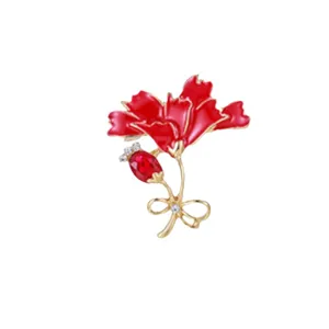 Close-up of elegant red enamel carnation flower brooch with gold finish and rhinestone
