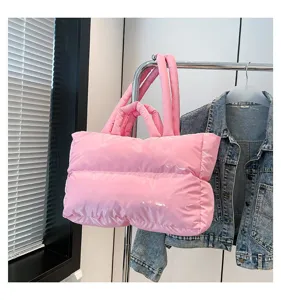 Close-up of a pink puffy space cotton tote bag hanging on a metal clothing rack