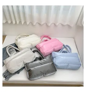 Variety of quilted puffer tote bags in pastel colors displayed on white surface