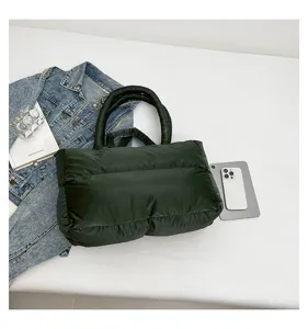 Top view of a dark green puffer shoulder bag with quilted space cotton texture