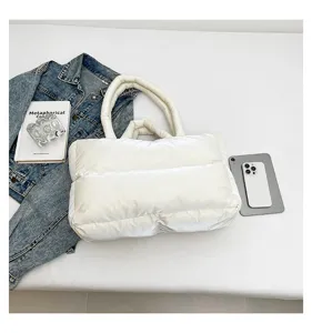 White puffer tote bag made of space cotton shown with denim jacket and accessories