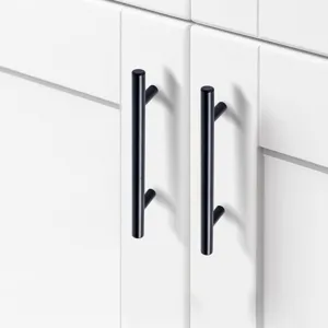 Modern matte black T-bar cabinet handles installed on white kitchen cupboard doors