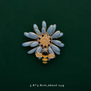 Detailed macro view of a blue enamel daisy brooch with a tiny golden bee accent