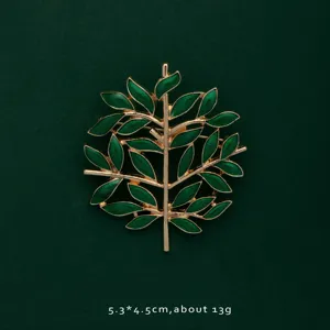 Detailed view of elegant green enamel leaf brooch with gold-plated finish and size info