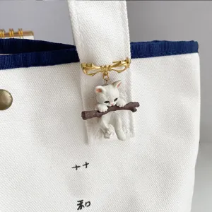 Handcrafted cute 3D kitten hugging a branch brooch pin for bags and clothing accessories.