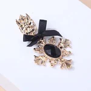 Detailed view of an elegant vintage brooch featuring a black bow and faceted stone accessory