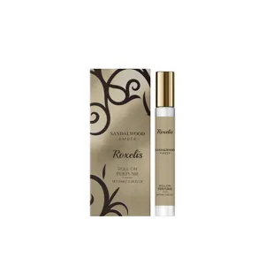 Sandalwood Amber roll-on perfume bottle and luxury packaging with gold accents.
