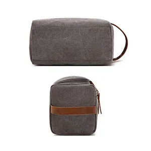 Grey canvas travel toiletry bag with leather handle and zipper for men and women