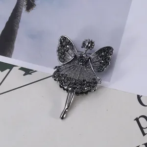 Detail view of a ballet dancer brooch featuring sparkling dark rhinestones