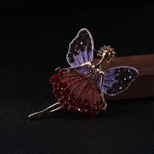 Close-up detail of a ballerina butterfly brooch with red and purple rhinestones