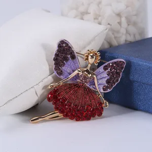 Detailed macro view of a ballerina brooch with purple wings and red crystal skirt