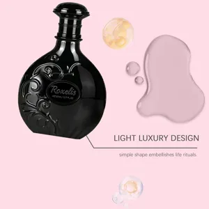Close-up detail of luxury black perfume bottle with ornate embossed scrollwork design.