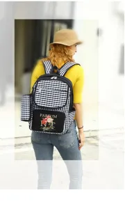 Rear view of woman wearing a black and white checkered backpack with floral print