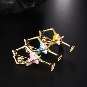 Detail view of colorful enamel ballerina skating girl brooches with gold finish.