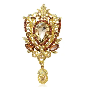 Elegante spilla barocca vintage dorata con cristalli ambrati e pietra centrale a goccia