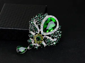 Luxurious emerald green glass crystal brooch with pear-shaped pendant