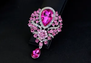 Detailed view of luxury pink water-drop crystal brooch with ornate silver alloy setting