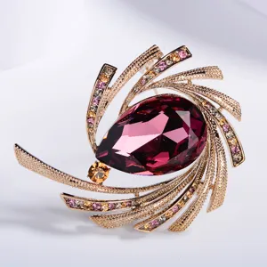 Elegant starburst brooch with large purple teardrop crystal and colorful rhinestones