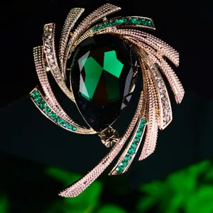 Elegant green teardrop crystal brooch with spiral rhinestone star pattern