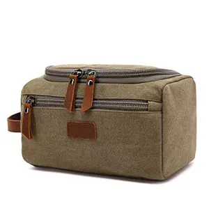 Detail view of a durable khaki canvas travel toiletry bag with leather pulls