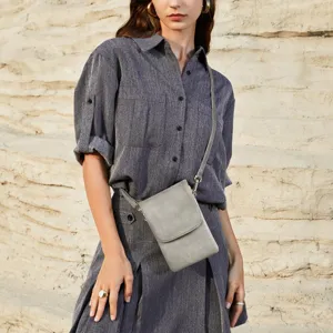 Elegant grey PU leather mobile phone crossbody bag for women styled with casual outfit