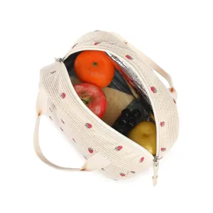 Macro view of insulated corduroy strawberry lunch bag interior filled with fresh fruits