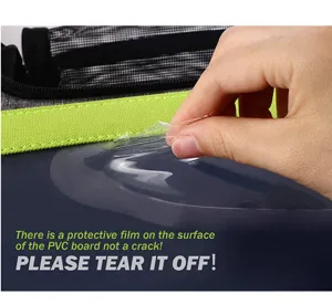 Close-up showing the protective film being peeled off the clear PVC pet carrier window.