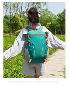 Lightweight waterproof hiking backpack with multiple pockets in teal and orange for outdoor adventures.