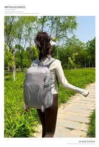 Outdoor scene detail showing a lightweight gray backpack with multiple compartments and side pockets.