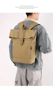 Detail shot of a khaki business casual backpack with magnetic buckle shown on a male model back