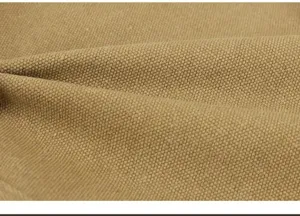 Macro detail view of durable khaki canvas fabric texture for business laptop backpack