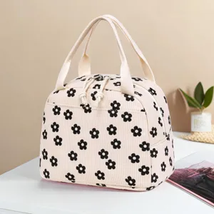 Corduroy floral lunch bag with black flower pattern and double handles for insulation
