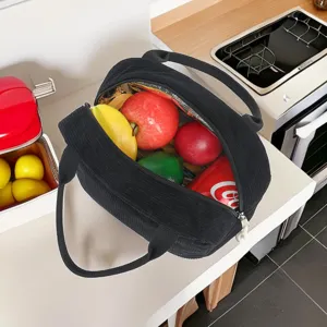 Interior view of black corduroy insulated lunch bag filled with fresh fruit and soda