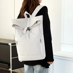 Urban casual laptop backpack with magnetic buckle shown on a model from a side-back view.