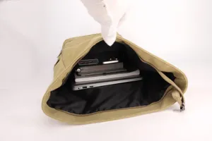 Internal compartment of the khaki canvas laptop backpack showing large capacity