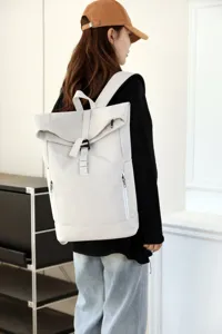 Urban roll-top backpack with magnetic buckle shown on model back