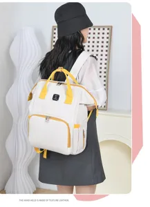 Model wearing a large white and yellow diaper backpack for stylish outdoor travel