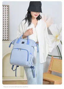 Asian model carrying a light blue large capacity mummy backpack in a lifestyle setting