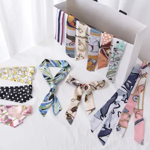 Detailed view of various vintage printed silk ribbon scarves for bags or hair styling