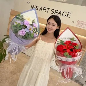 Elegant woman holding vibrant handmade soap flower bouquets of lilies and carnations