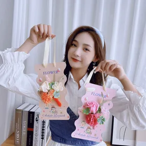 Handmade soap flower gift bouquet on decorative card held by model, perfect for teachers.