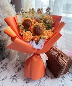 Detailed view of handmade crochet sunflower and rose bouquet with orange wrapping