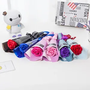Detailed view of colorful single rose soap flower bouquets arranged nicely on white desk.